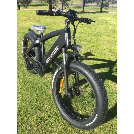 veloz amg electric moutain bike with fat tyre in black colour parked on grass