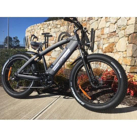 veloz amg electric mountain bike with fat tyres parked on sideway in australia
